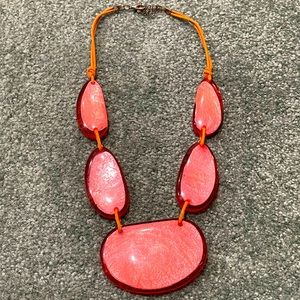 Peach acrylic necklace with leather cording.